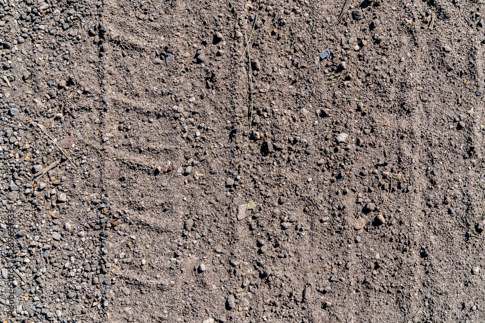 Slightly prominent tire tracks of the car on a gray ground
