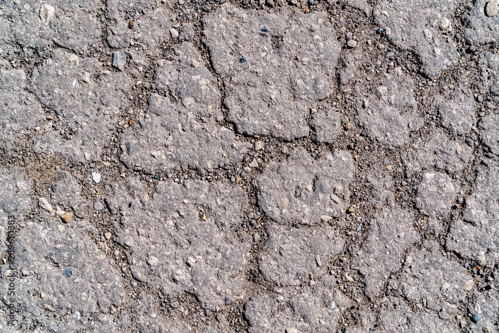 Cracked ground. Net of asphalt cracks. Gray background
