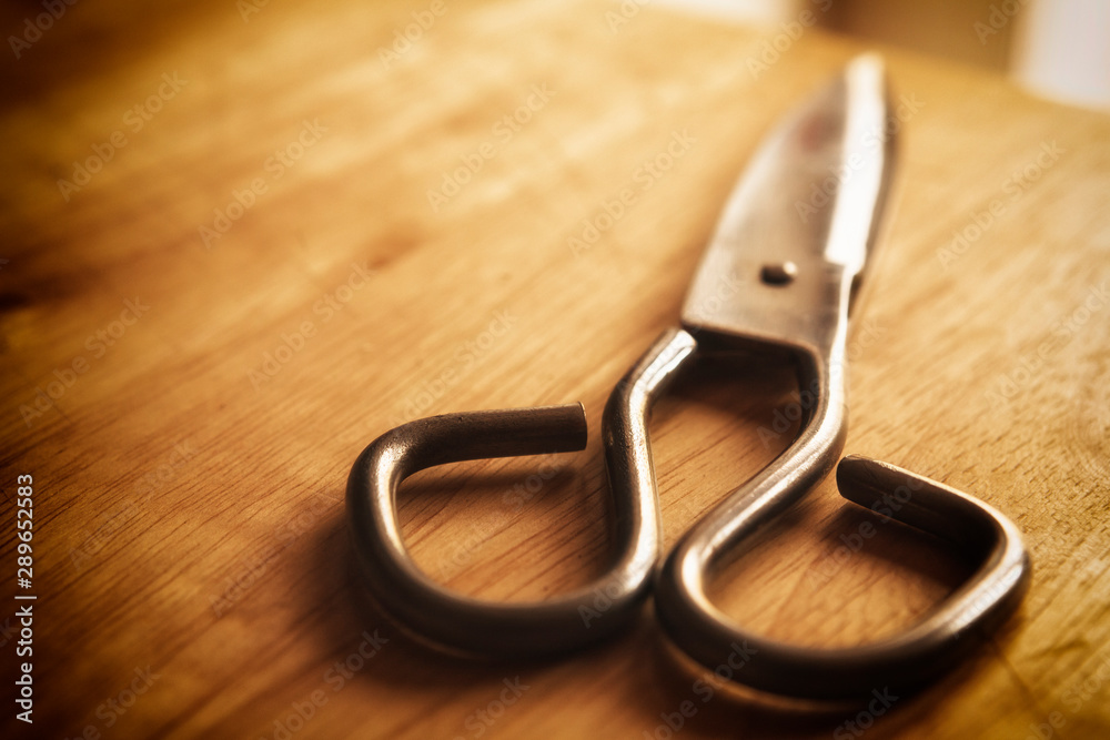 old scissors on the wooden background old scissors on the wooden background