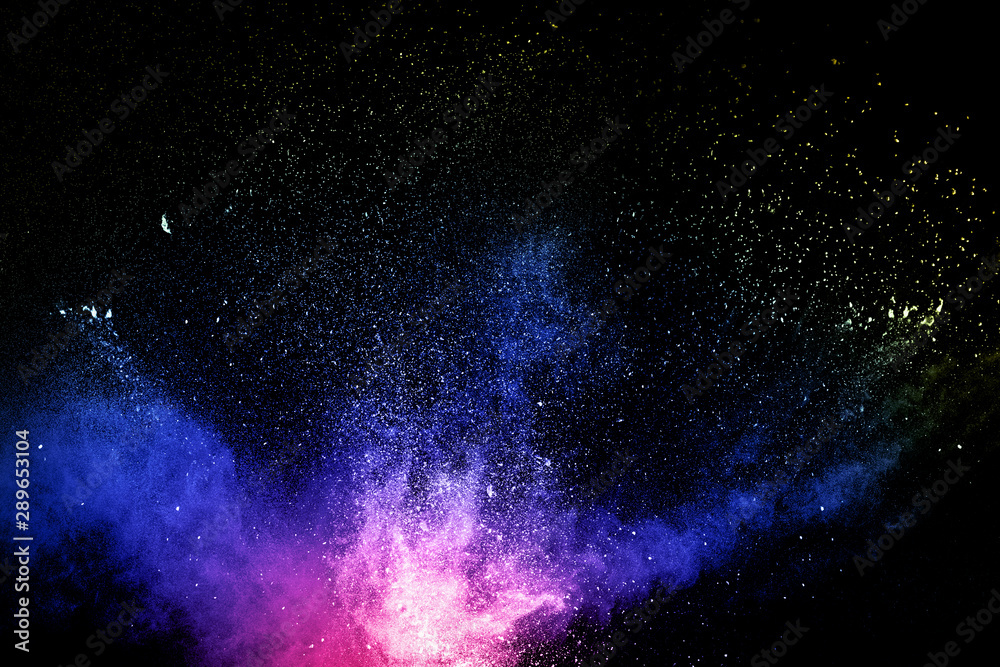 Obraz premium Multi colored powder explosion on black background.Colorful dust splash cloud on dark background.