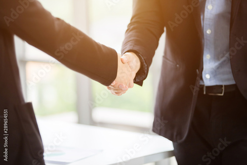 businesswoman and businessman shaking hands at In the office room after the contract is signed or handshake greeting deal