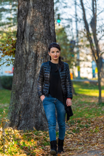 Young Woman Walking in a Park in Autumn