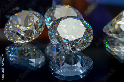 faceted gemstones. diamonds on a dark background