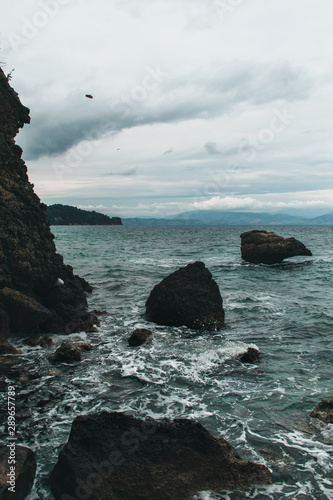 Vocation in Greece, Corfu. Water, cliff, mountains, and beautiful summer evening 