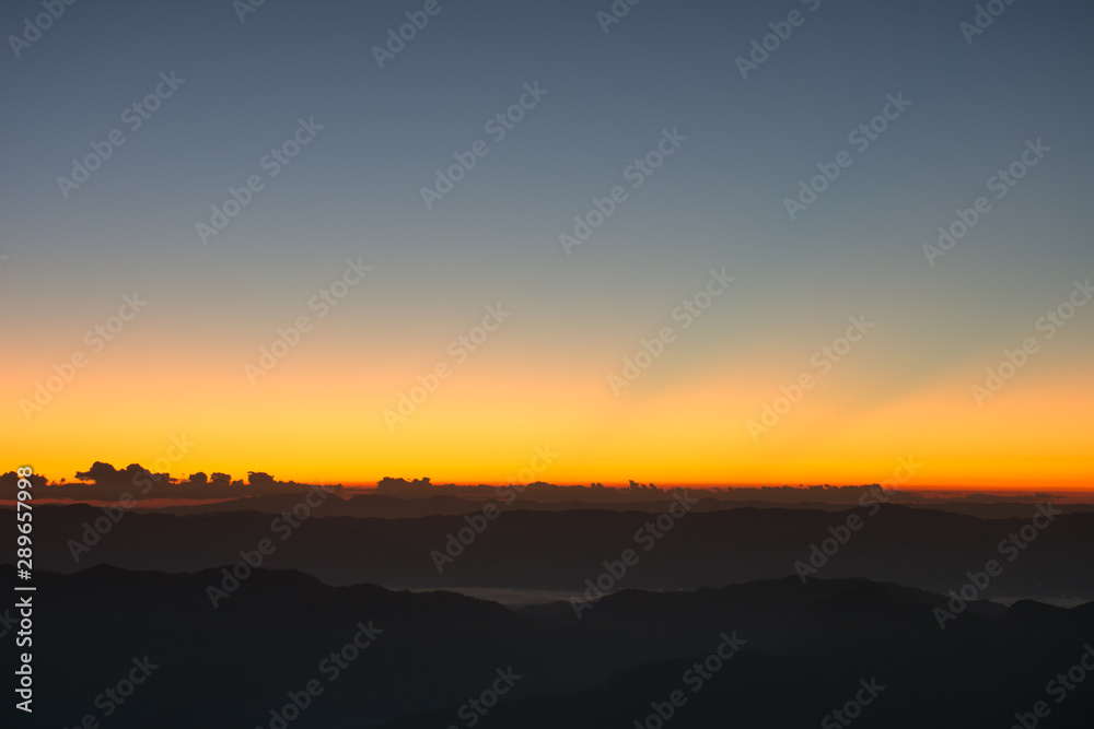 Dramatic sunset and sunrise over mountain morning twilight evening sky.