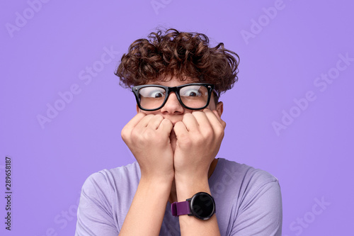 Scared teenager biting nails photo