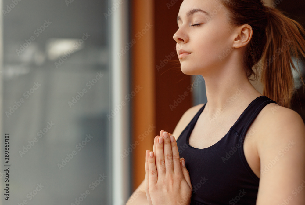 Young woman meditating with closed eyes