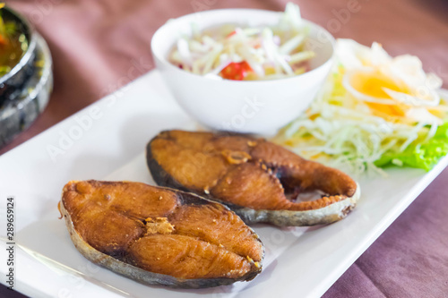 Fried king mackerel fish served with sweet and sour spicy sauce.
