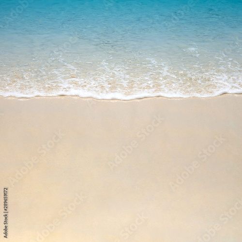 Blue sea wave on sand beach. Summer holiday relax background with copy space.