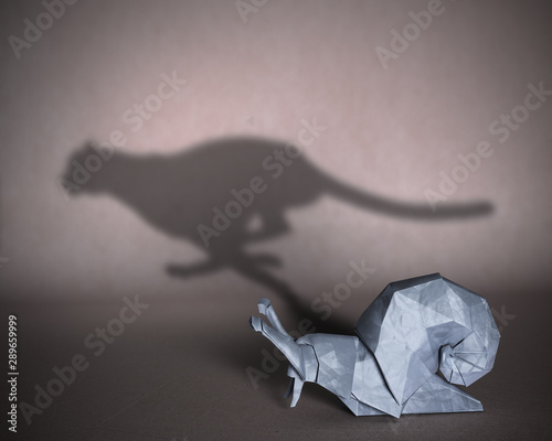 Concept of hidden potential. A paper figure of a snail that fills the shadow of a cheetah. 3D illustration photo