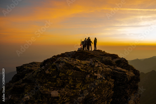 Group of tourists waiting for sunrise on the top of Fagaras mountains, Romania, looking towards Moldoveanu Peak