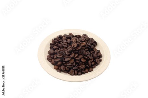 Coffee beans in a porcelain plate isolated on white background