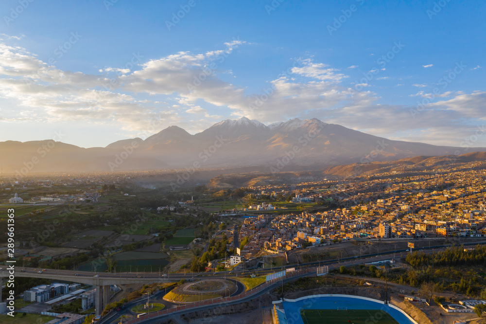 Aerial view of a sunset in Arequipa city with Chachani volcano as background, Peru
