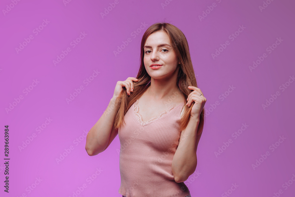 Portrait of a girl in a pink t-shirt on a purple background Portrait of a girl in a pink t-shirt on a purple background