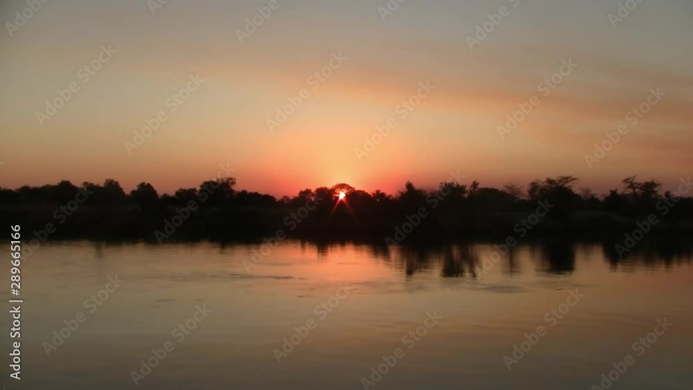 Romantic Sunset on the Okavango River with Beautiful Orange Colors in Namibia, Africa Romantic Sunset on the Okavango River with Beautiful Orange Colors in Namibia, Africa