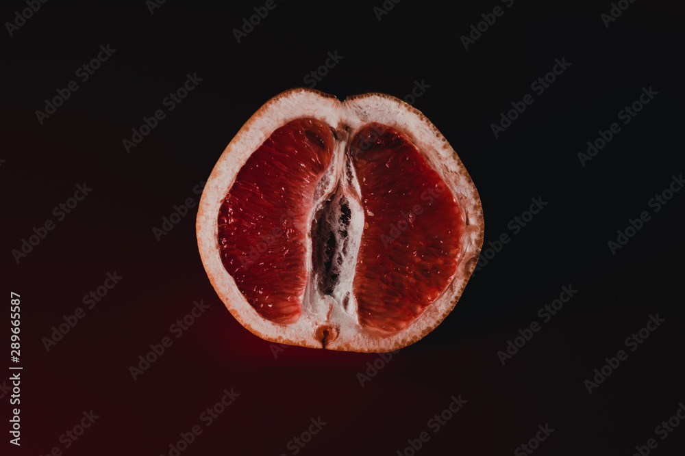 Red grapefruit looking like female vagina, vulva symbol. Sexual