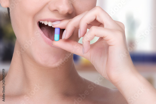 girl holding a pill . reception of medicines. happiness from vitamins
