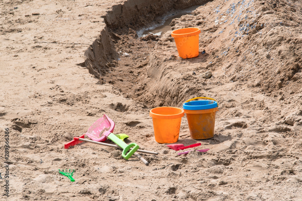 Shovel next to a sand castle on a beach in Brittany Shovel next to a sand castle on a beach in Brittany