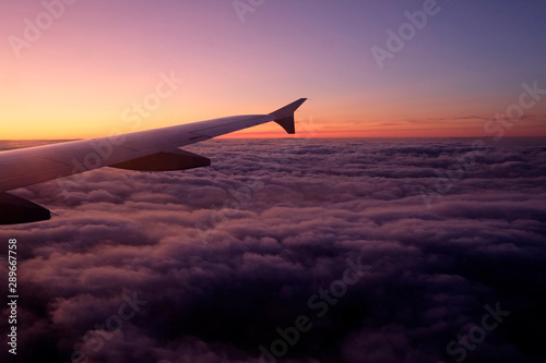 Airplane window seat view - flying into the sunset