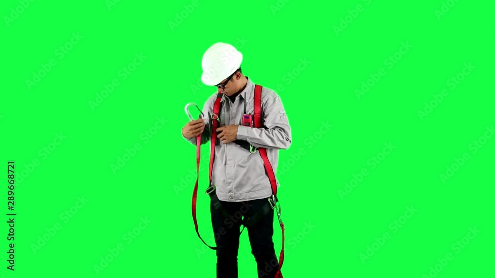 Man wearing personal protective equipment standing on green screen background. Safety and industrial concept Man wearing personal protective equipment standing on green screen background. Safety and industrial concept