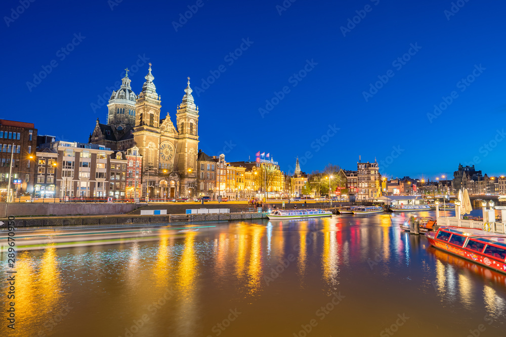 Amsterdam city with Saint Nicholas church and canal in Amsterdam city, Netherlands