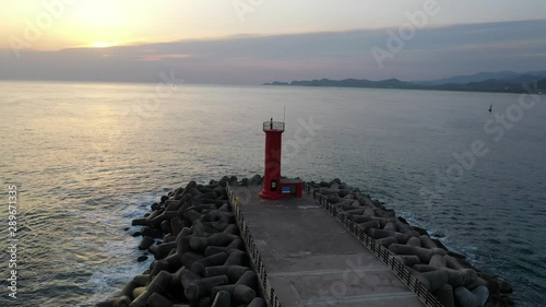 a red lighthouse filmed with a drone