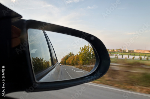 Looking in the side rear-view mirror during the traffic jam