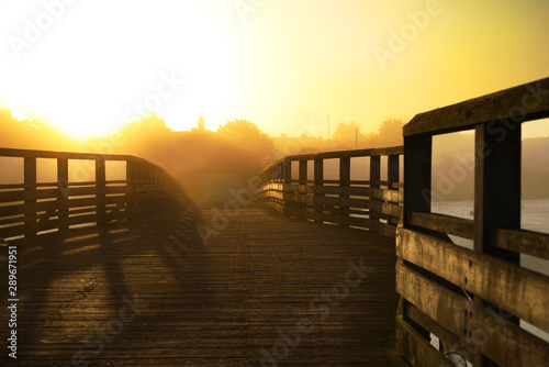 footbridge in the mist at early morning sunrise