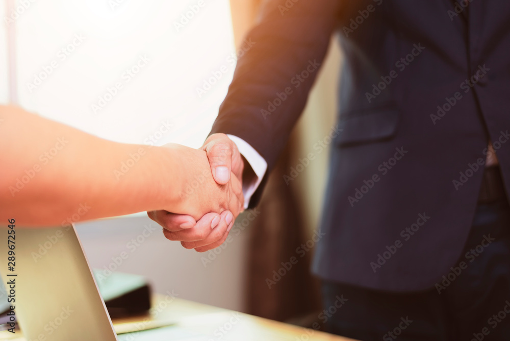 Asian businessman and businesswomen Handshaking.Successful businessmen handshaking after good deal.Handshake Gesturing People Connection Deal Concept.