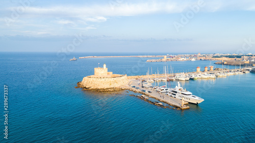 Panorama with Mandraki port, lagoon and clear blue water. Famous tourist destination in Europe
