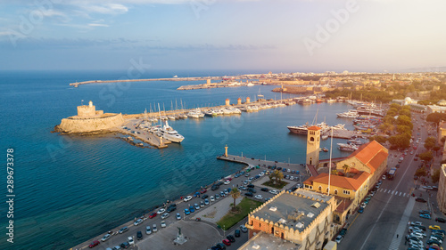 Aerial view of Mandraki port in Rhodes city. Beautiful panorama of the old city of Rhodes island at sunset, Greece.