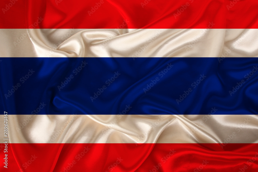 Fototapeta premium photo of Thailand national flag on a luxurious texture of satin, silk with waves, folds and highlights, closeup, copy space, travel concept, economy and state policy, illustration