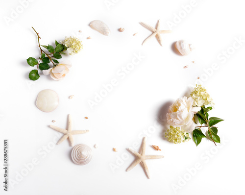 Wreath frame with roses, shells, starfish isolated on white background. flat lay, overhead view.