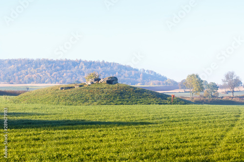 Stone Age grave on a hill in a rural landscape