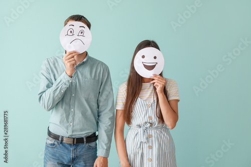 Couple hiding faces behind ...