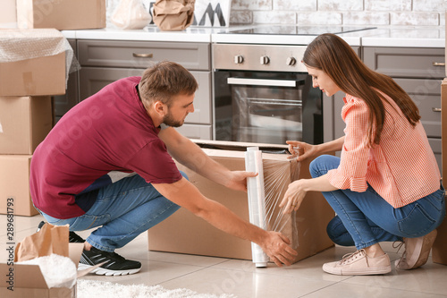 Young couple packing things before moving into new house