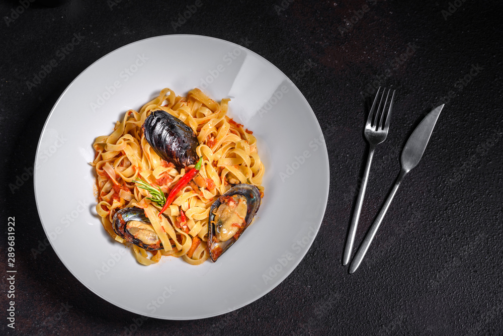 Homemade pasta with mussels, sprinkle with chopped parsley and basil. Delicious of pasta with mussel Homemade pasta with mussels, sprinkle with chopped parsley and basil. Delicious of pasta with mussel