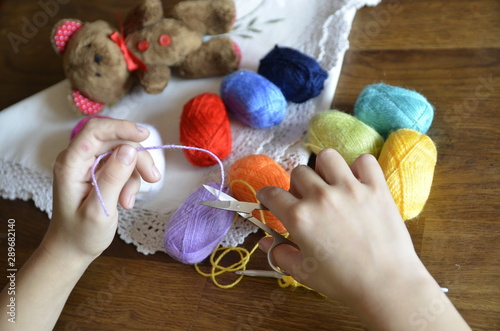 Hobby. Crochet things. The child learns to knit, thread, crochet hooks, scissors.