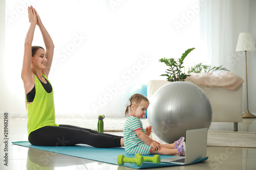 Sporty mother with little d...