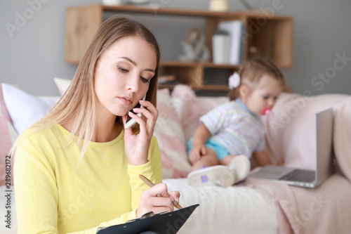 Busy mother working from ho...