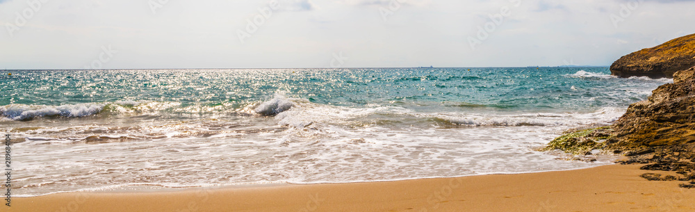 Close up of the sea water affecting the sand on the beach, sea waves calmly flowing sand, relaxing view
