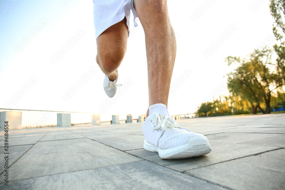 Handsome sporty man running outdoors, closeup Handsome sporty man running outdoors, closeup