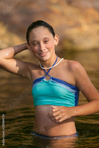 Young teenage girl swimming in a stream in Stowe, Vermont