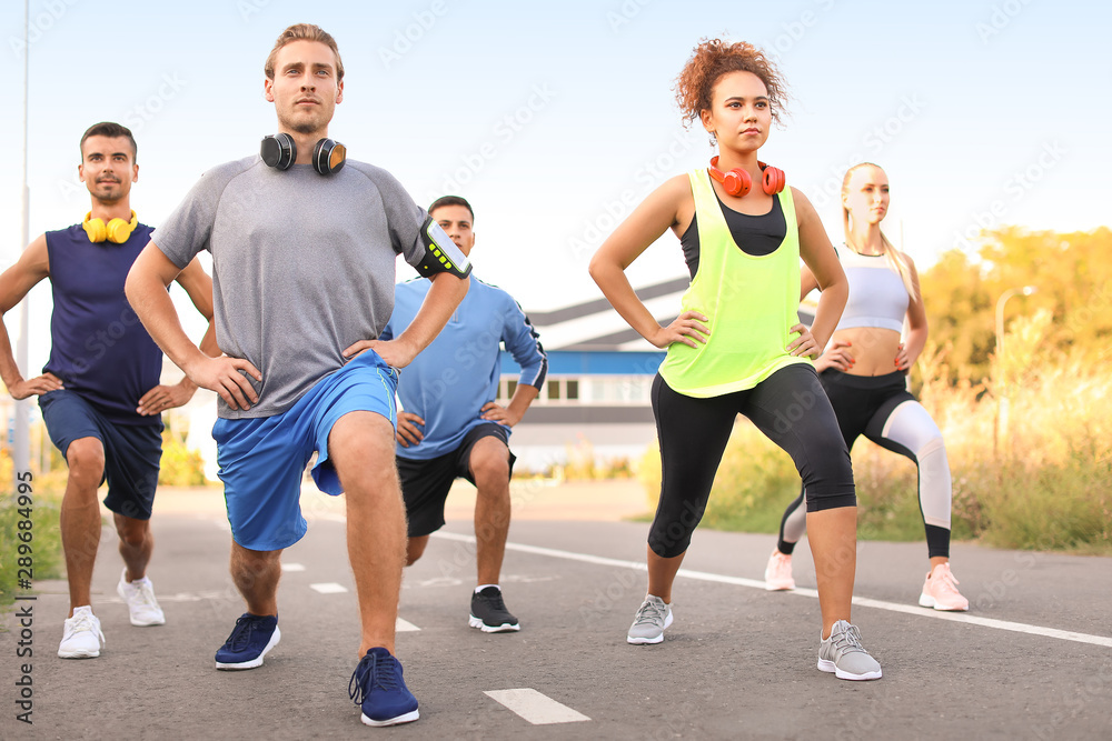 Obraz premium Group of sporty young people training outdoors