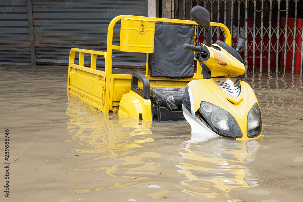 Car driving on a flooded road, The broken car is parked in a flooded road. . Car driving on a flooded road, The broken car is parked in a flooded road. .