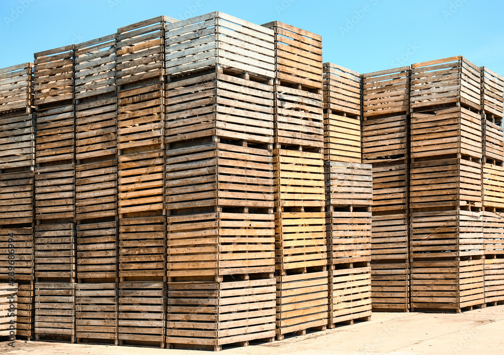 Pile of empty wooden crates outdoors on sunny day Pile of empty wooden crates outdoors on sunny day