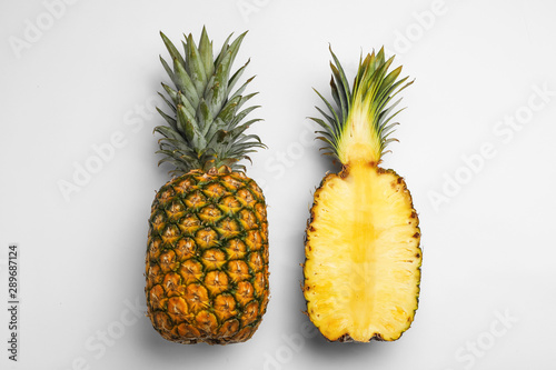 Tasty raw cut pineapples on white background, top view