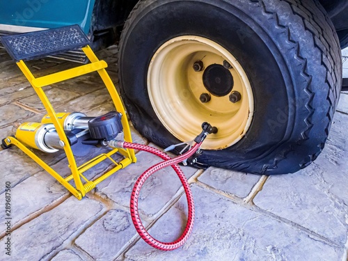 Flat tire and air pumper tool fixing and refill air to old tire of golf cart.