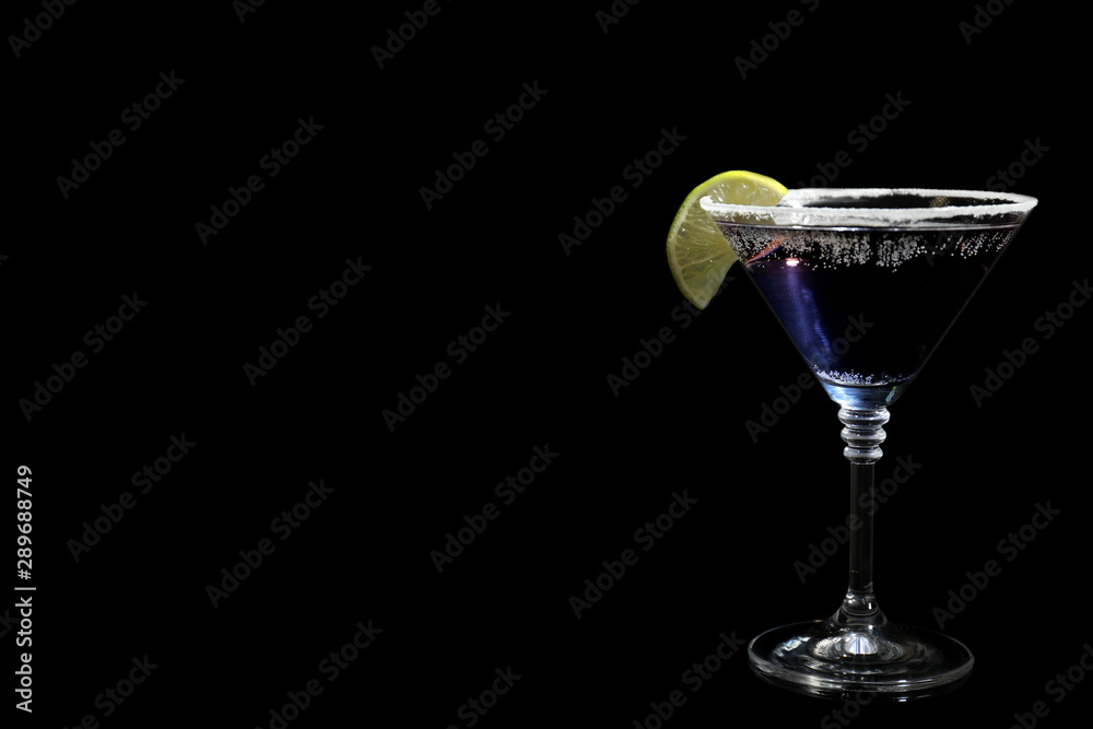 Glass of delicious cocktail on black background. Space for text