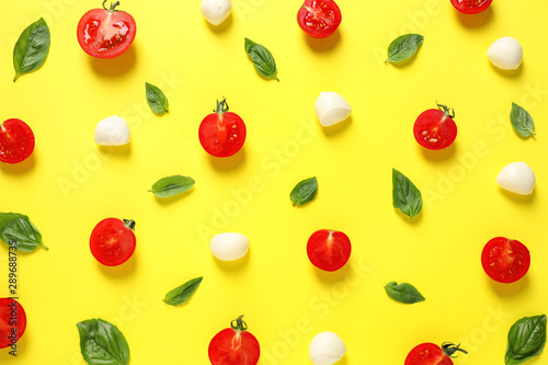Flat lay composition with fresh ingredients for pizza on yellow background
